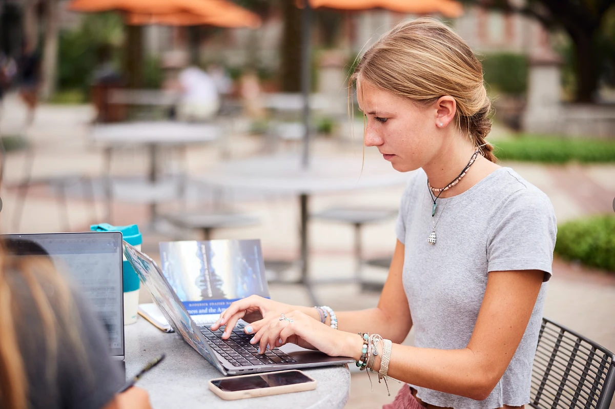 Flagler student typing on a laptop